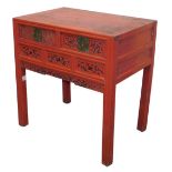 A Chinese red lacquer side table, with two short frieze drawers, with carved blossom, above a carved