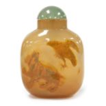 A Chinese agate scent bottle, decorated in relief with an animal and bird, 7cm high.