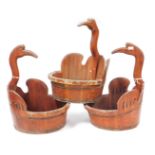 Three Chinese wooden swan shaped buckets, each with a curve, swan's head and neck handle, 59cm high,