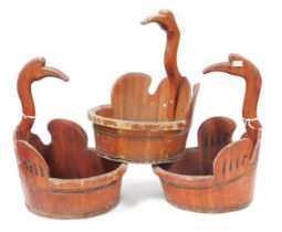 Three Chinese wooden swan shaped buckets, each with a curve, swan's head and neck handle, 59cm high,