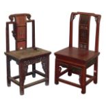 Two Chinese red lacquered chairs, with carved panelled splats, solid seats, raised on square legs un