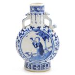 A Qing dynasty blue and white porcelain moon flask, decorated centrally with figures in a garden wit