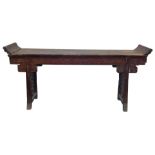 A Chinese hardwood altar table, the scroll ended top above a carved frieze, raised on trestle suppor