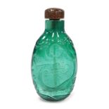 A Chinese green glass snuff bottle, with moulded foliate decoration, 8cm high.