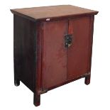 A Chinese red lacquered cupboard, with a pair of doors opening to reveal a single shelf, raised on s