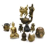 A group of Chinese brassware, including a pair of lion dog candlesticks, a dragon teapot, a four fac
