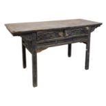 A Chinese hardwood side table, with two carved drawers, over a carved frame, raised on square legs,