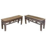 A pair of Chinese elm benches, each with a carved frieze, raised on square legs, 48.5cm high, 113cm