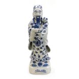 A Chinese blue and white porcelain figure of the deity Lu Xing, modelled standing holding a baby, 53