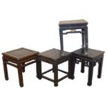 Four hardwood and lacquered square side tables, one with a rattan top.