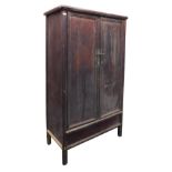 A Chinese hardwood wedding cabinet, the pediment over a pair of doors opening to reveal two shelves