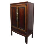A Chinese tricolour hardwood wedding cabinet, with a pair of panelled doors opening to reveal a sing