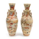A pair of 20thC Japanese Satsuma vases, of foliate twin handled form, decorated with reserves of Sam