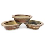 Three Chinese hardwood and brass bound rice baths, of oval form, with brass inserts, 53cm wide, 41cm