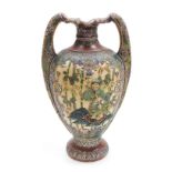A Japanese Satsuma twin handled vase, decorated to the obverse in bas-relief with a figure in a boat