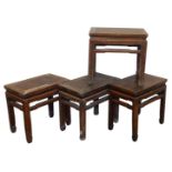 Four Chinese rectangular hardwood occasional tables, variously carved, raised on square legs,