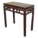 A Chinese hardwood side table, with a carved frieze, raised on square legs, 87cm high, 90.5cm wide,