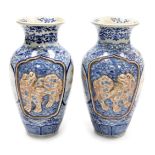 A pair of Meiji period Japanese blue and white vases, of shouldered, tapering form, decorated with r