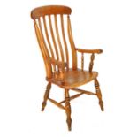 A Victorian elm and beech lath back kitchen chair, with solid saddle seat, raised on turned legs uni