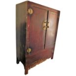 A Chinese hardwood wedding cabinet, with two doors above a base with carved decoration, on square fe