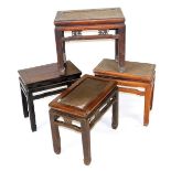 Four Chinese hardwood stools, three with rattan seats, 50cm high, 51-56cm wide.