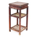 A Chinese hardwood urn stand, of square section, with a square undertier above a pierced undertier,