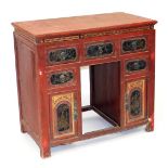 A Chinese red and gilt lacquer kneehole desk, with a painted top above a carved frieze and five pai