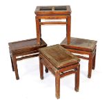 Four Chinese hardwood occasional tables, of rectangular form, raised on square legs, 50cm high, 52cm