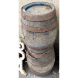 A pair of early 20thC oak and cast iron bound beer barrels, 54cm high. (AF)