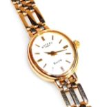 A Rotary Elite lady's 9ct gold cased wristwatch, oval white dial bearing gold batons, on a 9ct gold