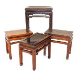Four Chinese hardwood occasional tables, of rectangular section, raised on square legs, 49cm and 51c