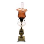 A Victorian cut glass and brass oil lamp, with a glass chimney and fluted cranberry glass shade, 81.
