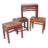Four Chinese hardwood occasional tables, of rectangular section, raised on square legs, 49cm and 53c