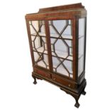 An early 20thC mahogany display cabinet, with two astragal glazed doors enclosing two shelves, above