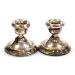 A pair of Elizabeth II loaded silver squat candlesticks, Birmingham 1970, 6cm high, 9.55oz all in.