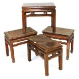 Four Chinese hardwood occasional tables, of rectangular section, raised on square legs, 47cm and 50c