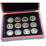 A collection of twelve silver gilt commemorative crowns 2010, cased.