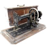 A late 19thC Frister and Rossmann sewing machine, serial number 22550/35**50, wooden cased.