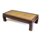 A Chinese hardwood rectangular occasional table, with a rattan top, raised on square block feet, 47c