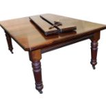 A Victorian mahogany dining table, with one extra leaf and two half leaves, raised on turned and flu