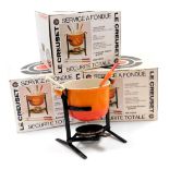 Three Le Creuset fondue sets, number 6000, each comprising pot, burner, and fondue forks, all boxed.