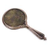 A George V silver and tortoise shell backed hand mirror, London 1925.