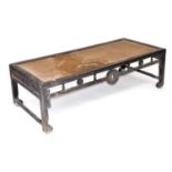A Chinese hardwood and rattan table, of rectangular form, with a carved galleried frieze, raised on