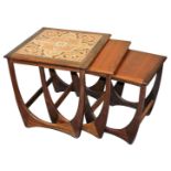 A G-Plan nest of teak occasional tables, the largest table with a four tile inset top, largest table