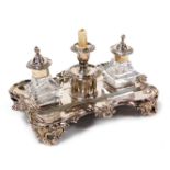 A Victorian silver plated desk stand, of serpentine form, with a gadrooned and floral embossed borde