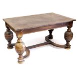 An early 20thC oak refectory dining table, raised on cup and cover supports, united by a shaped stre