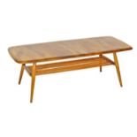 An Ercol light elm coffee table, the oblong shaped top raised on turned legs united by an undertier,
