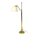 An early 20thC brass telescopic standard lamp, the scrolling side arm with a pleated shade, raised o