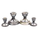 A pair of George V loaded silver candlesticks, of squat form, Birmingham 1922, 6cm high, and a pair