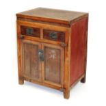 A Chinese hardwood side cupboard, with two drawers over a pair of cupboard doors, raised on stiles,